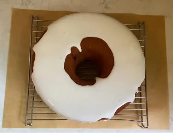 Pour Lemon Glaze on Blackberry Lemon Bundt Cake