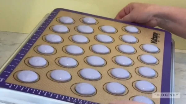 French Macarons Tap Pan on Counter