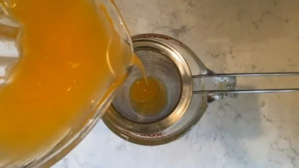 Frozen Wild Blueberry Muffins Pour Orange Juice Through Strainer